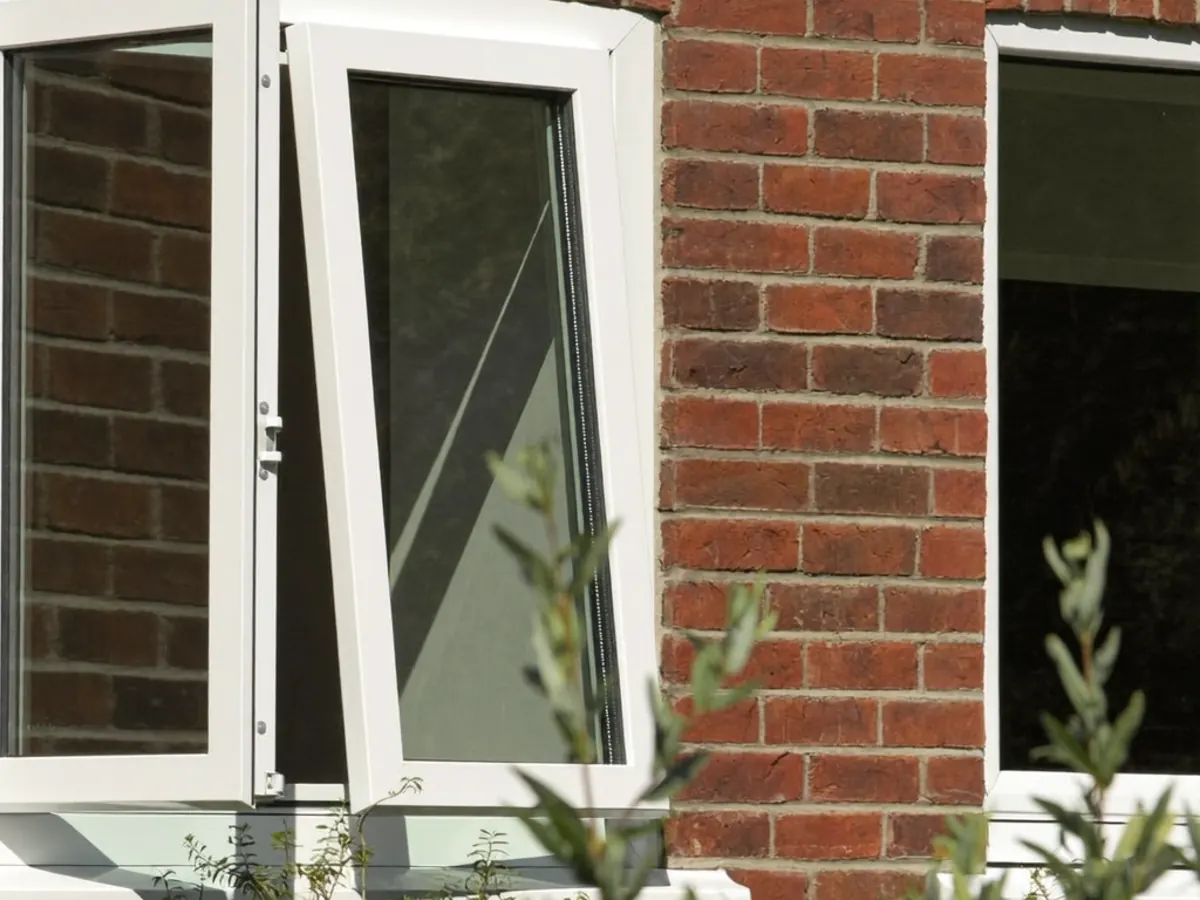 An open casement window on a rural UK cottage