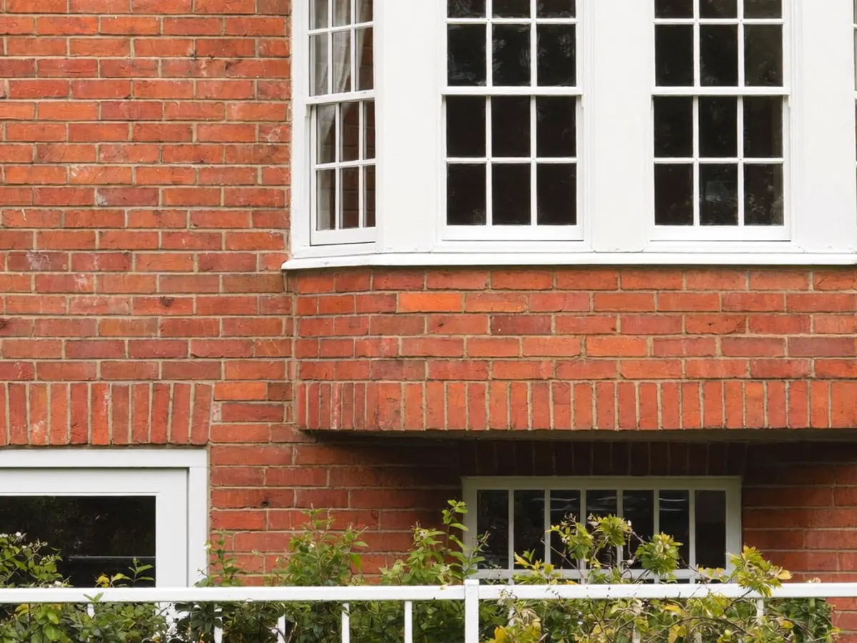 Front door and windows of a UK terraced house from the street
