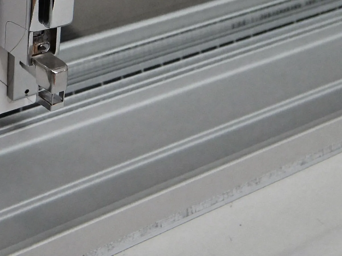 A poorly sealed window frame with visible gaps around the edge