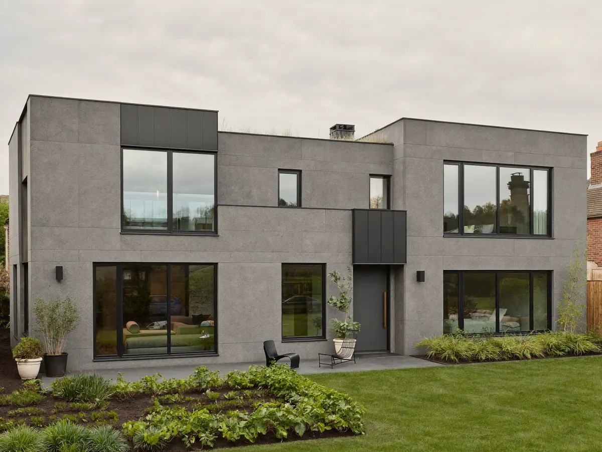 A modern rendered house with dark anthracite grey double glazed windows