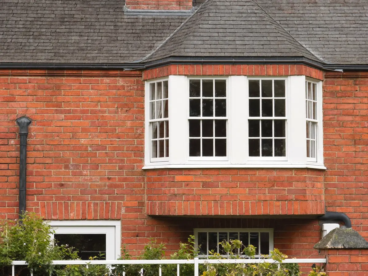 A traditional sliding sash window on a Victorian terraced house