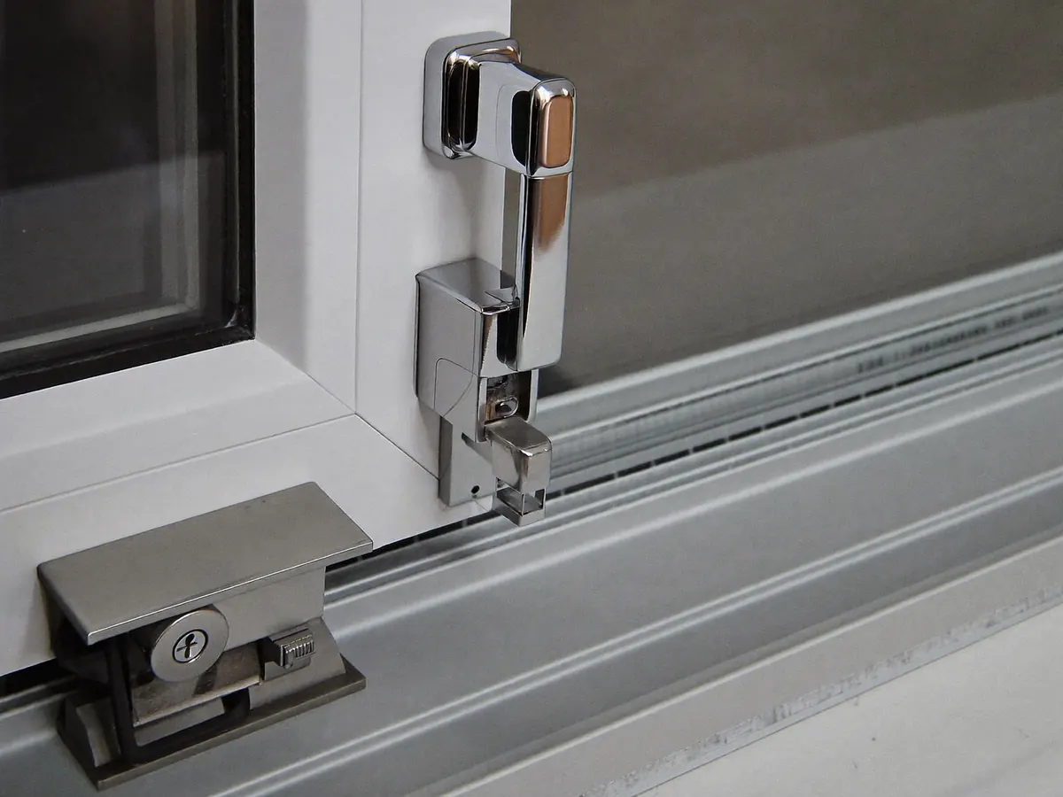 Close-up of a window handle and multi-point locking mechanism on a uPVC frame